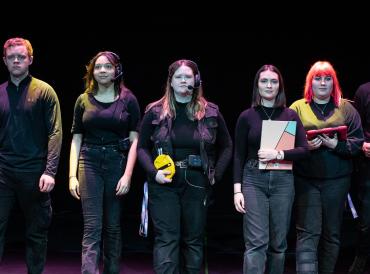 Production and Technical Arts stage management students stood in a line in the Sainsbury Theatre.